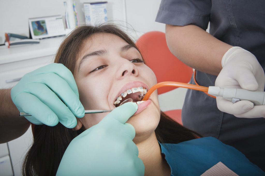 Dentist and dental nurse with patient